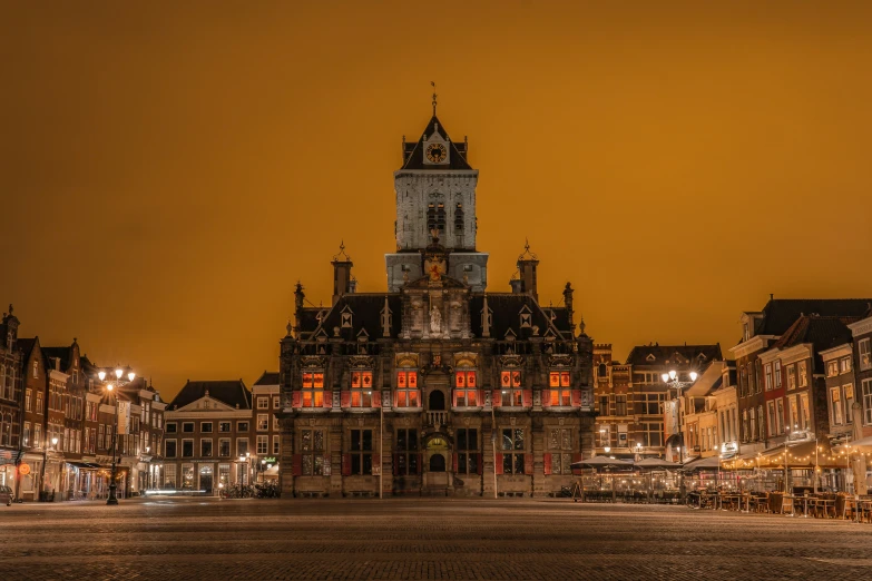 an old clock tower lit up over a city