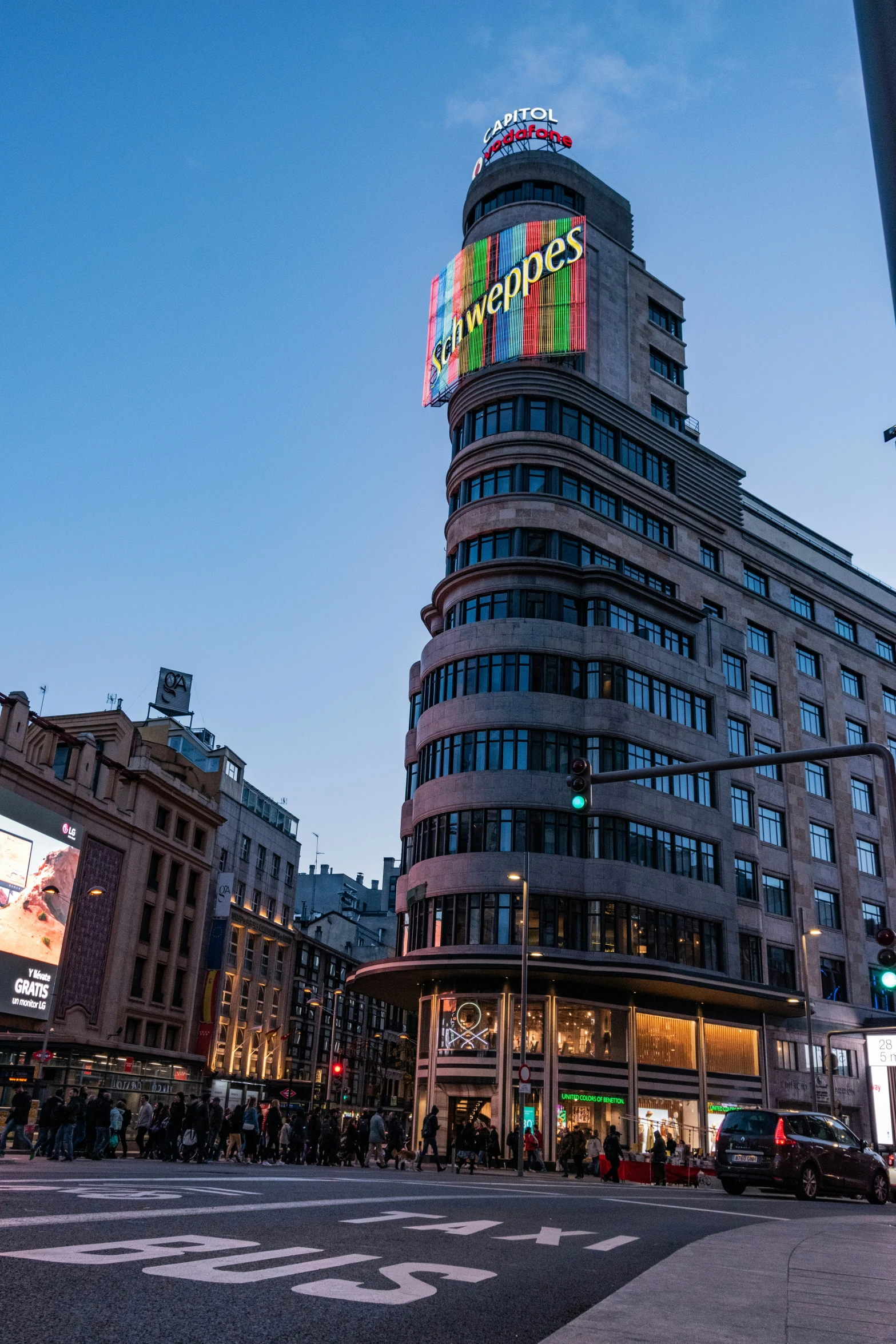 the lights on the building glow brightly from the street