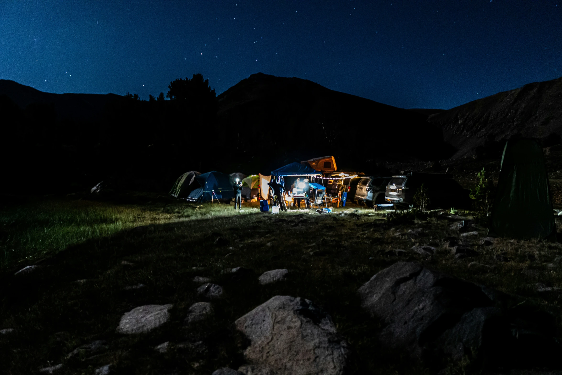 the night sky over a group of tents