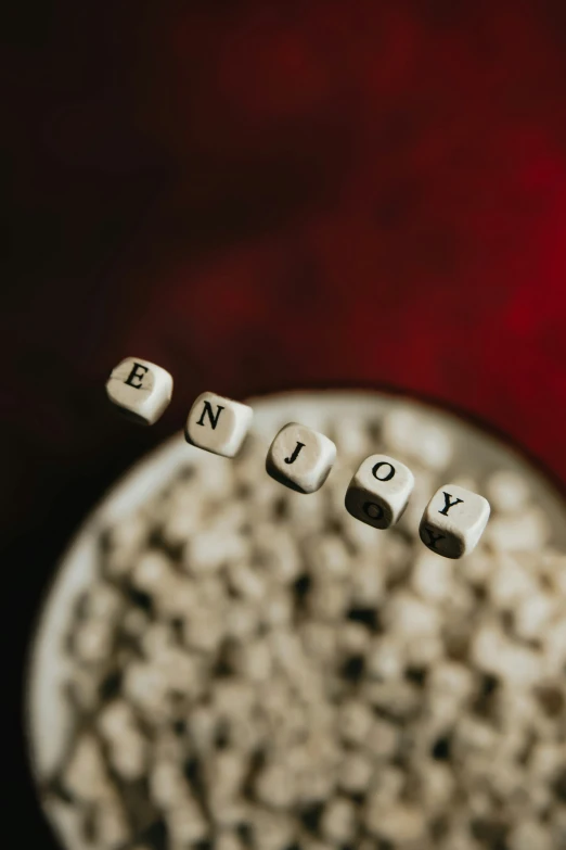 the word enjoy spelled on blocks in a bowl
