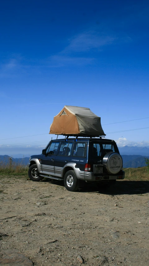 an suv with a roof tent on the side