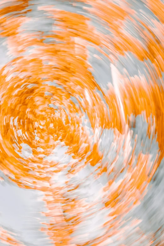 circular motion blurs across the sky as an orange and white object