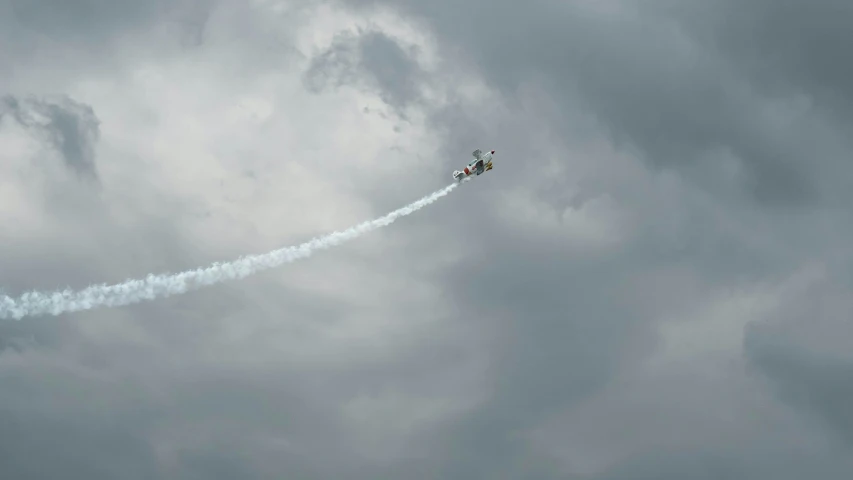 two airplanes making smoke trails in the sky