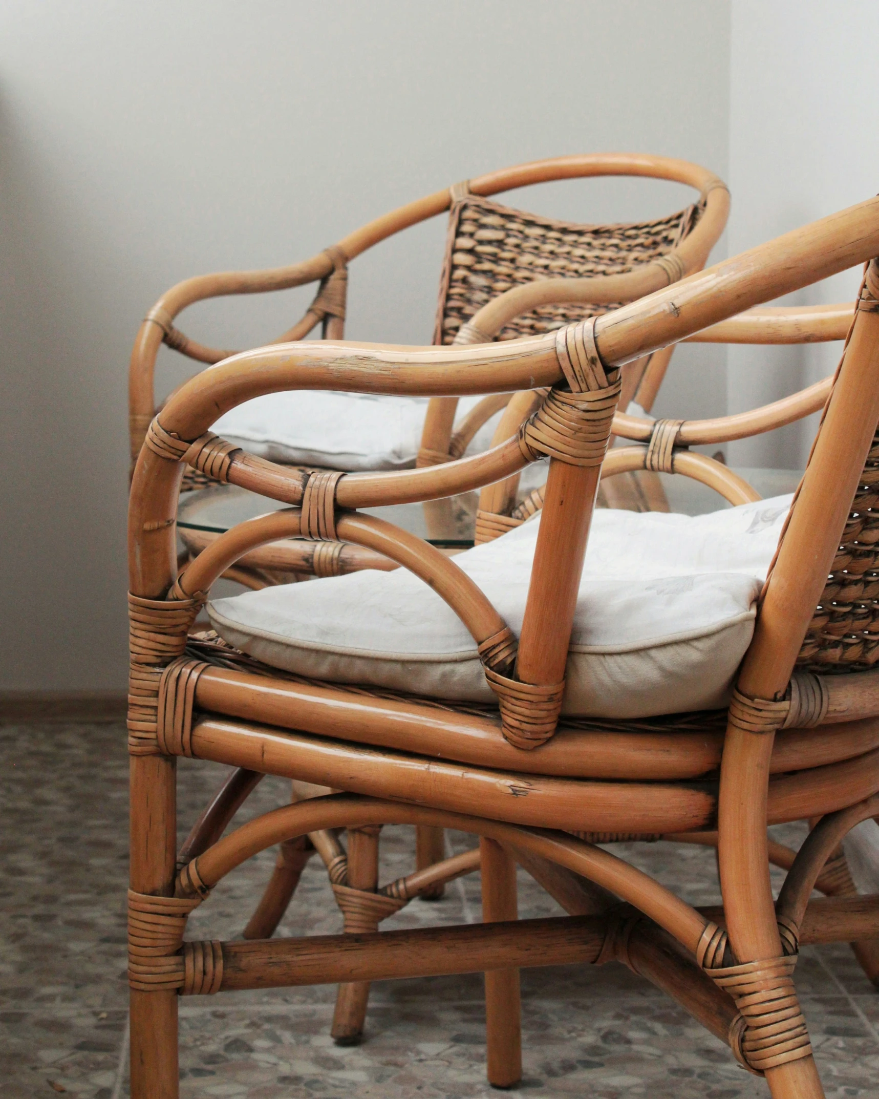 a set of four bamboo chairs with cushions