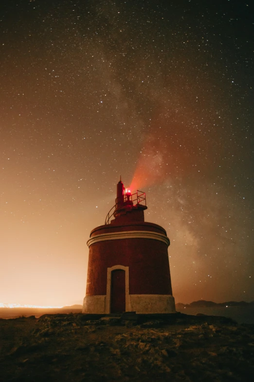 the light tower at night has stars shining on it