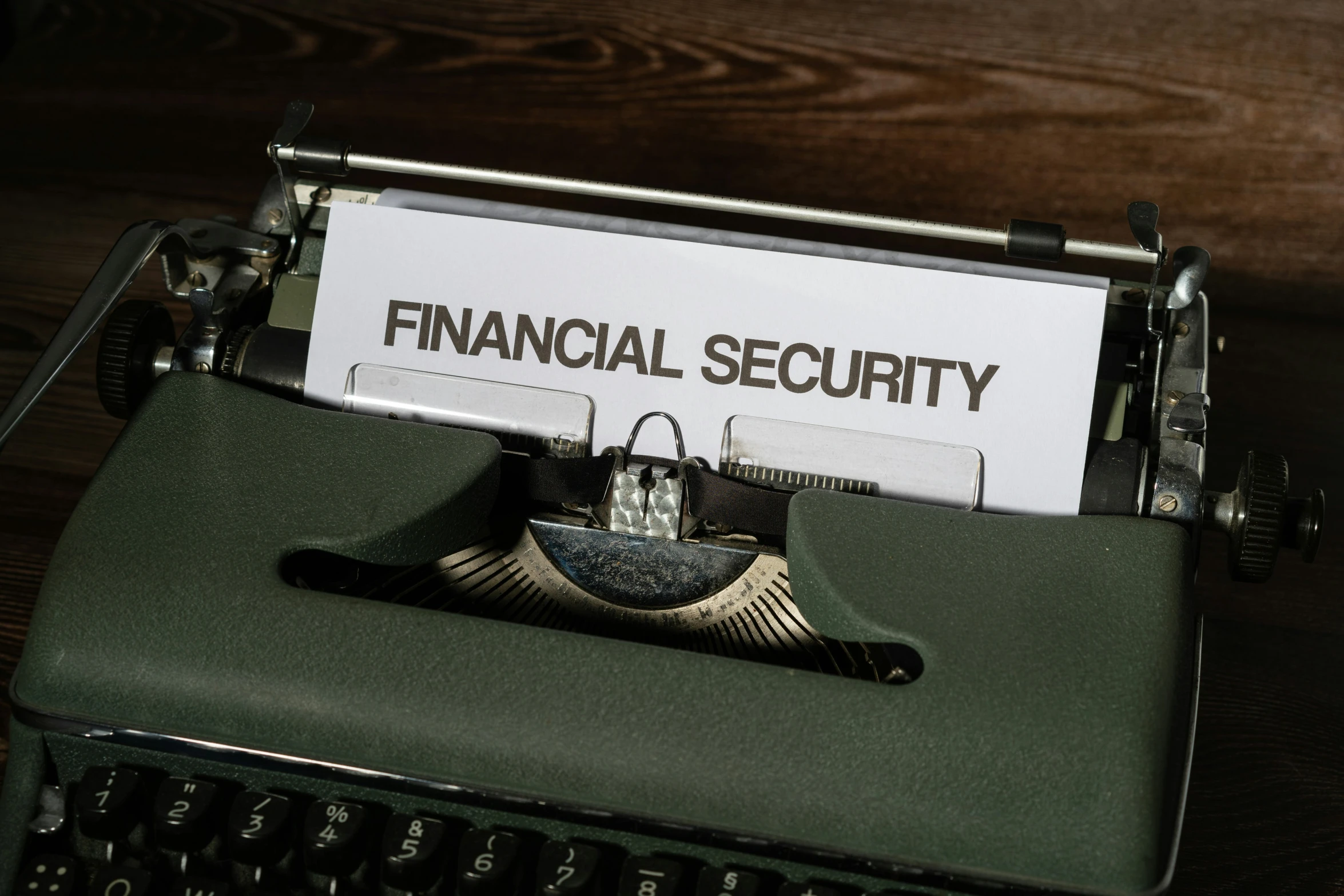 a close up of an old fashioned typewriter with a financial security sign