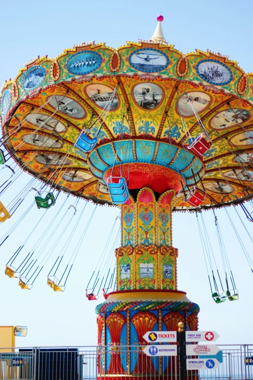 a ferris ride in an amut park with swings and clocks