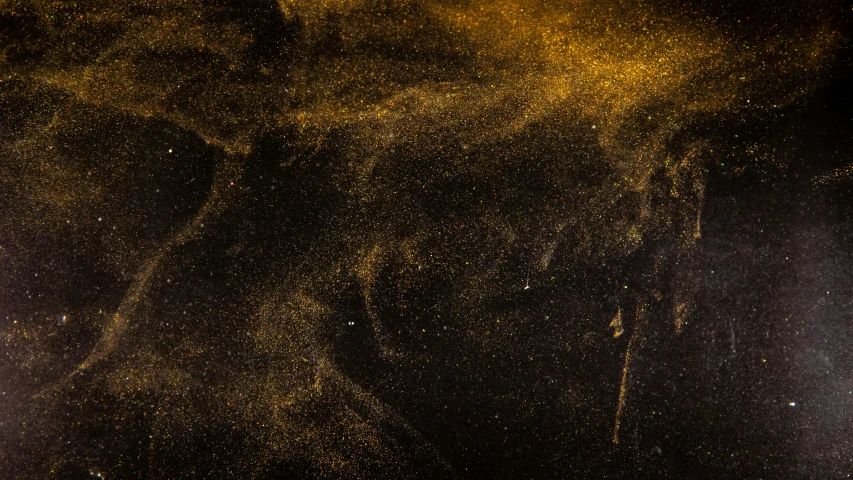 a large amount of yellow powder on the dark background