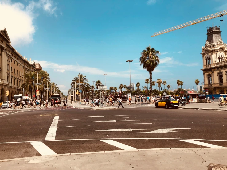 an intersection with cars parked and construction vehicles on the corner