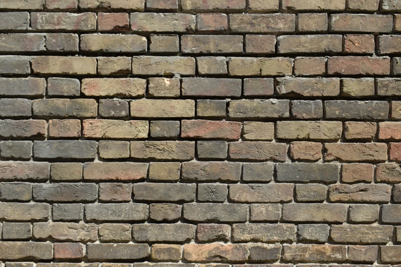 a stop sign on a brick wall with bricks below