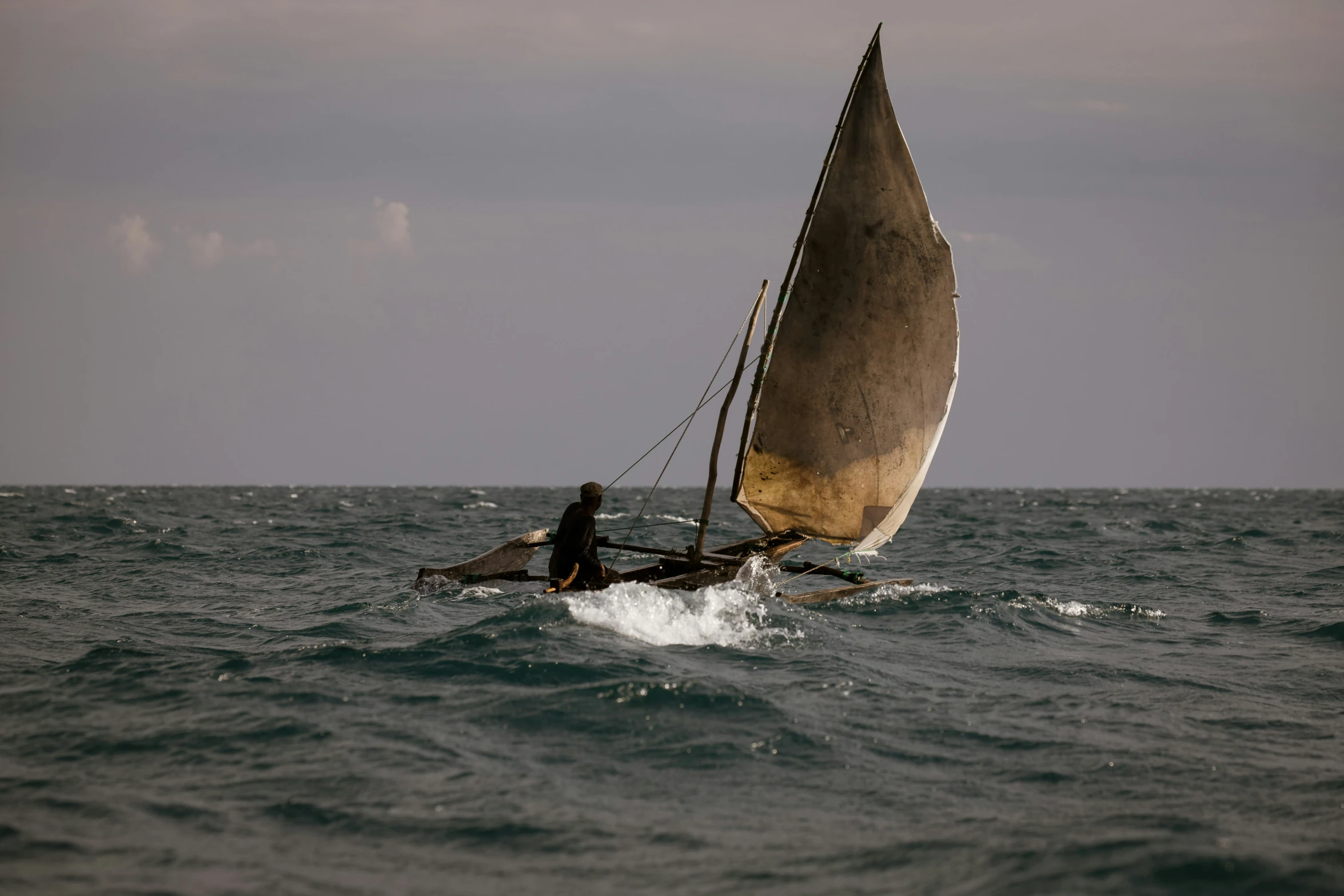 man sailing in an empty boat in rough waters