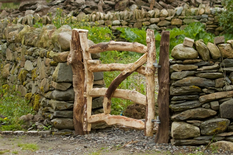 a wooden gate made out of a pile of rocks