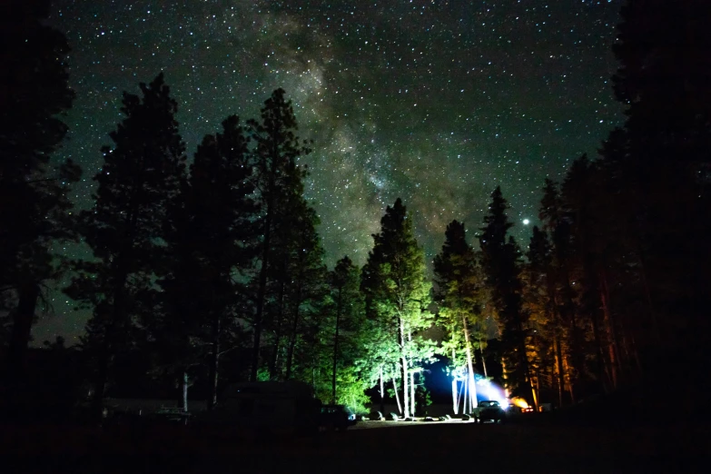 a view of night sky from a campsite