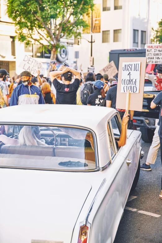 people holding signs protesting against the government