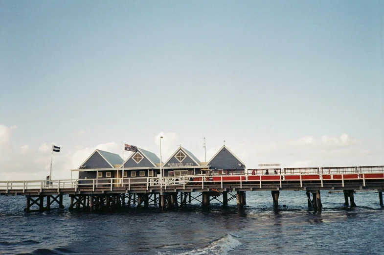 there are many piers across the water, with people walking on one side