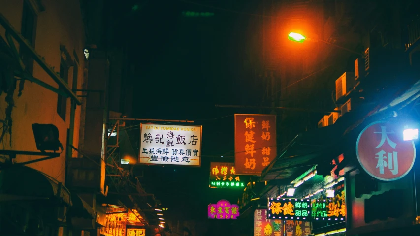 a dark street is lit up with streetlights