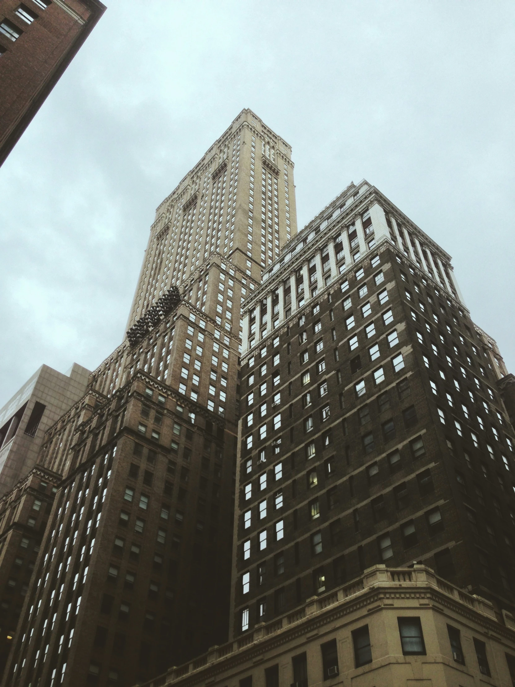 two building side by side looking upwards at the sky