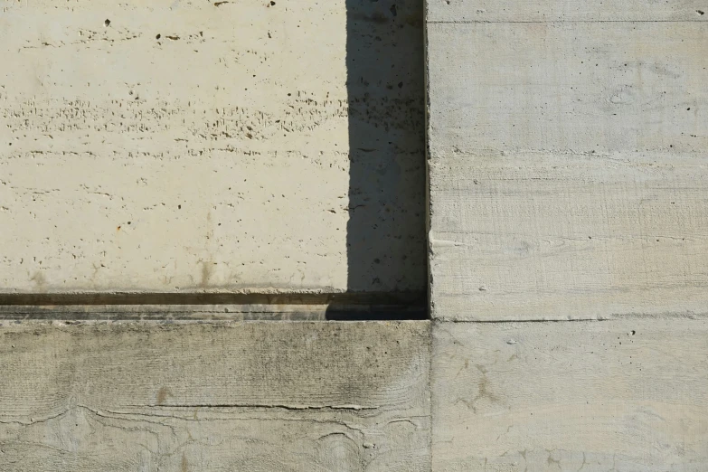 a red fire hydrant is in a cement wall