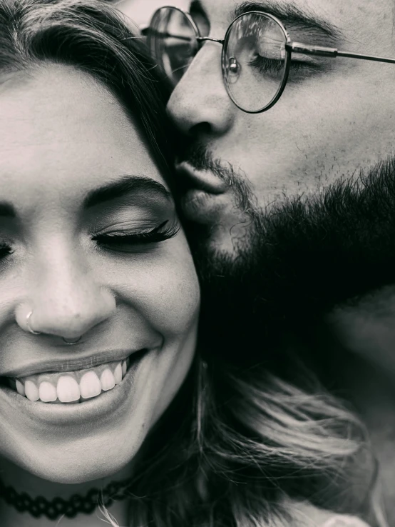 black and white po of a man kissing a beautiful woman