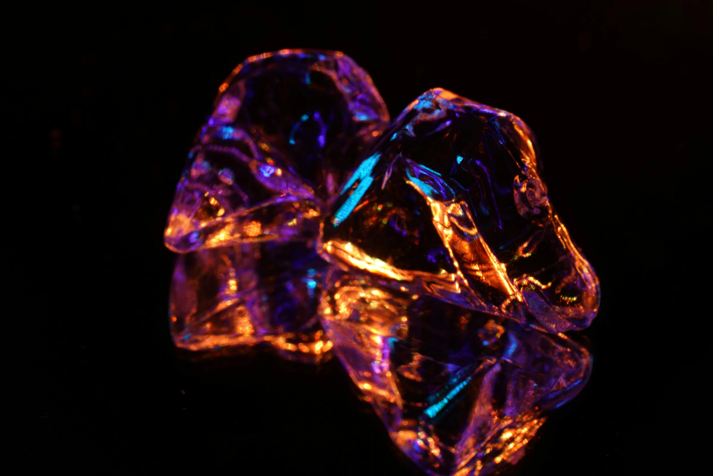 two shiny diamond shaped object displayed in bright lighting