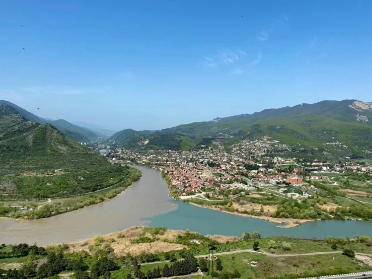 an aerial view of a small village and river