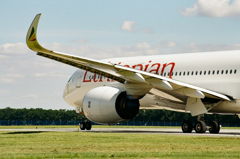 a white plane sitting on a runway at an airport