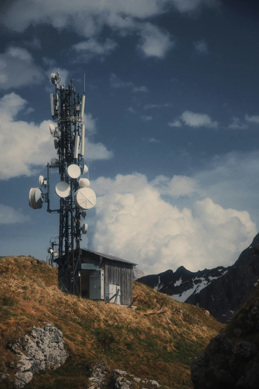 a tall antenna tower sitting on top of a hill