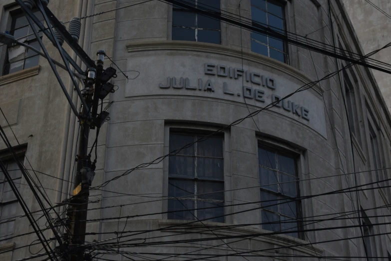 a very tall building next to telephone wires