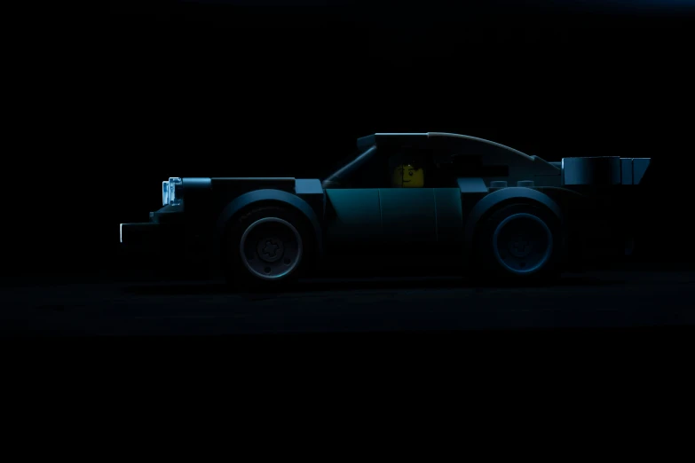 a car made out of legos in the dark