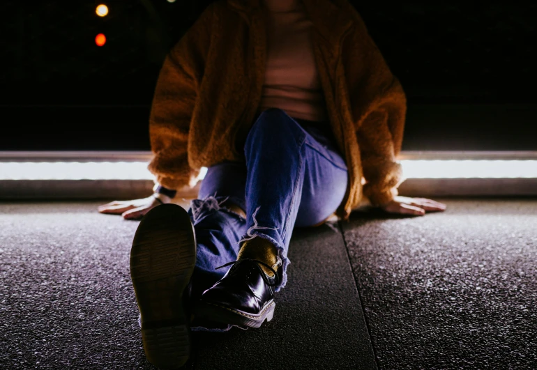 a persons legs and legs sit in the street