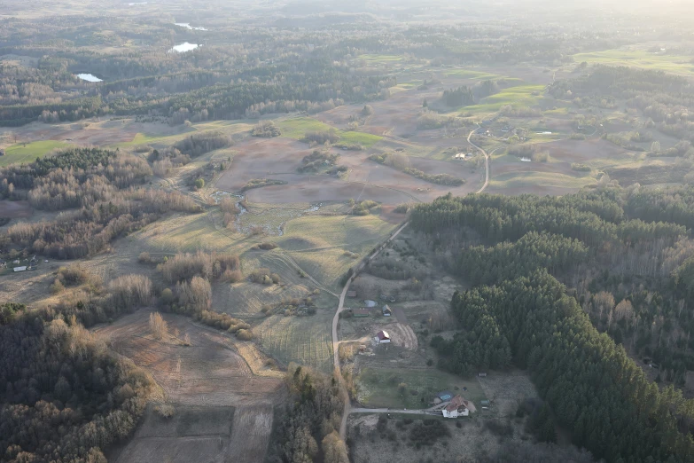 an aerial view shows trees, land and hills