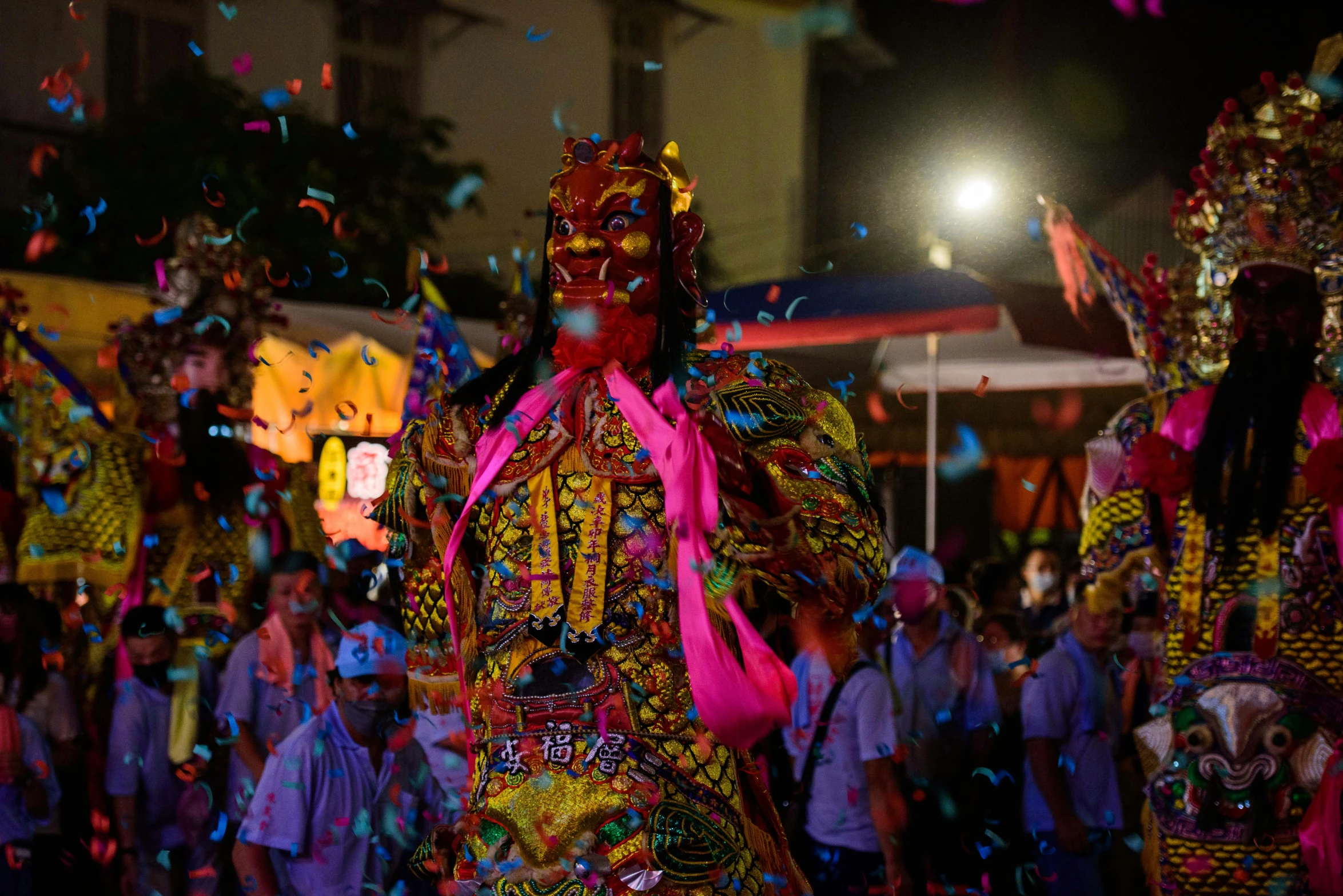 a woman wearing costume with a ribbon around her neck and confetti in the air