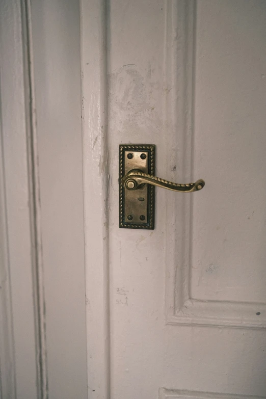 a door handle on a white door in a building