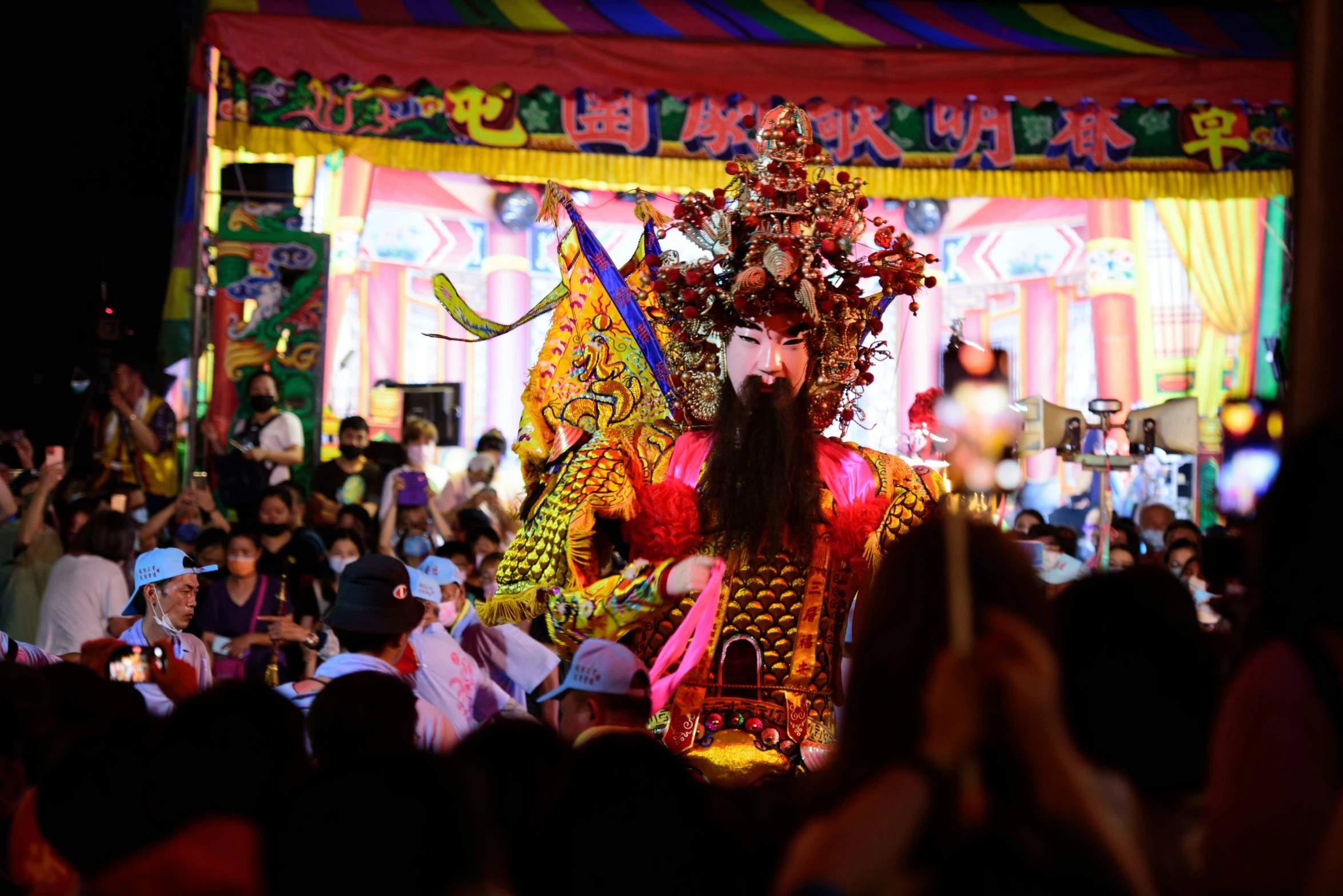 a parade that features a face mask and an elaborate costume