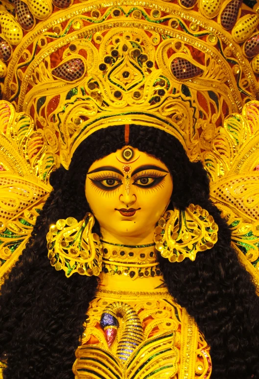 a woman dressed in a golden costume with black hair