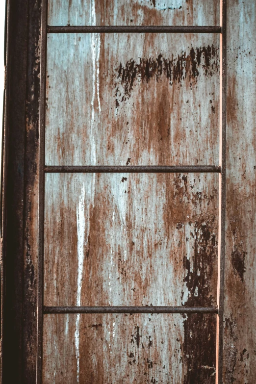 the rusted iron bars of an old metal door