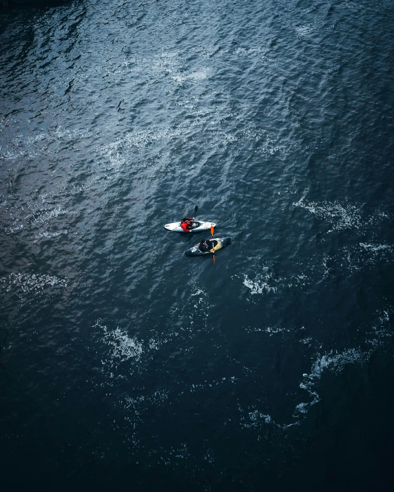 a view of a man on his surfboard in the ocean