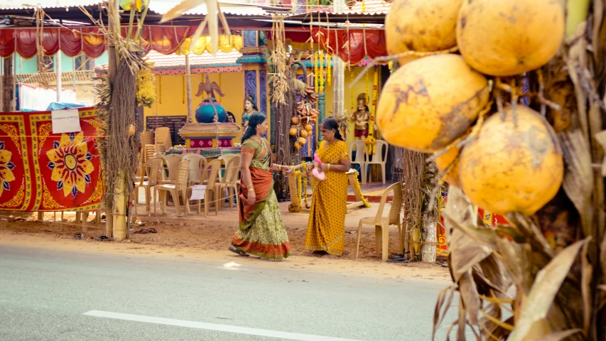 a woman is standing by some food in the street