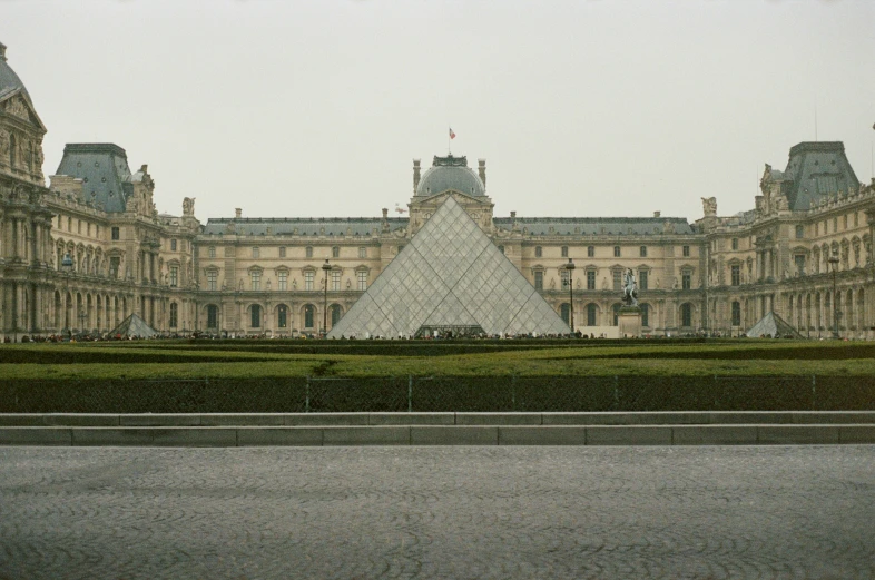 a large glass pyramid sitting in front of a large building