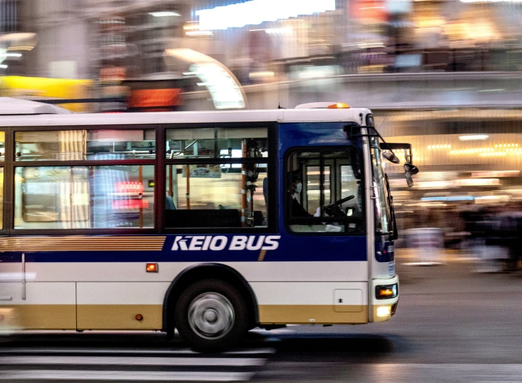 a city bus that is next to a car