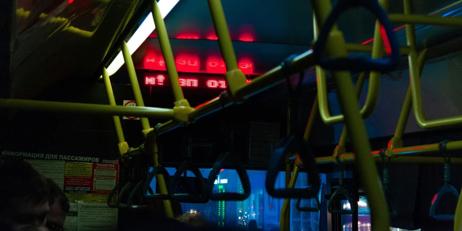 the interior of a train with red and yellow seats