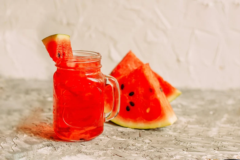 a watermelon drink is made with juice and some type of fruit