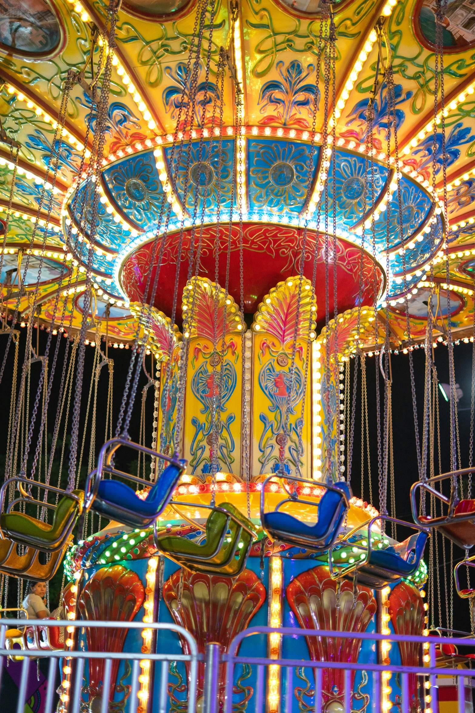 some colorful chairs and lights at the carnival