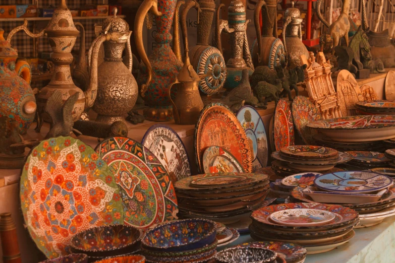 plates, bowls and other ceramic art on display at an outdoor store