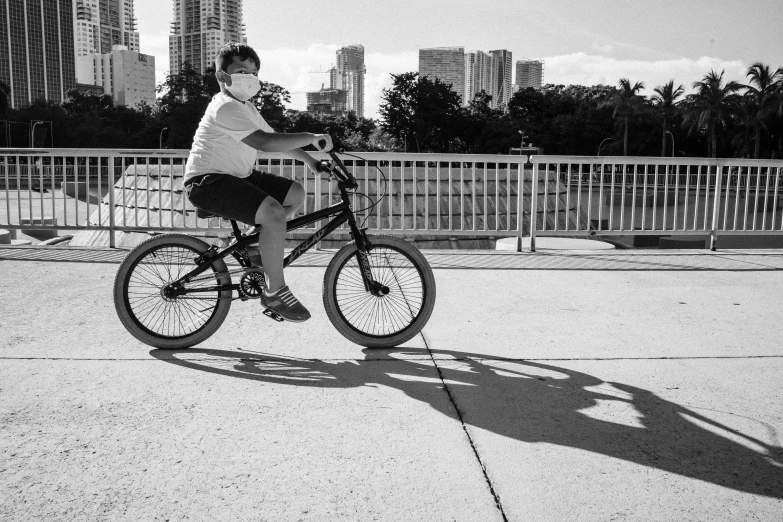 a man riding his bike on the sidewalk