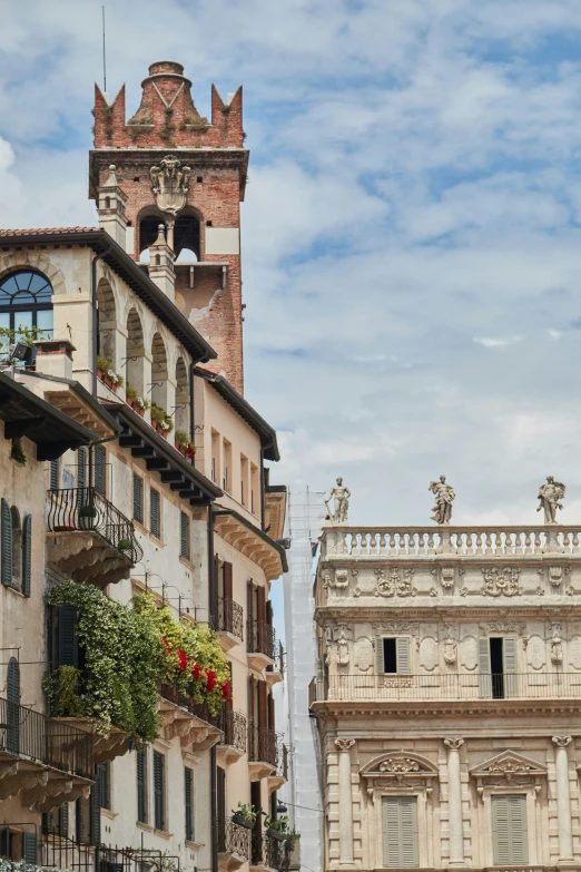 buildings with balconies and flower baskets outside of them