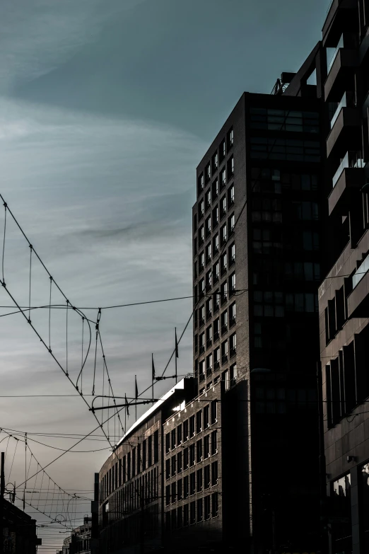 two buildings along a street with wires in the air