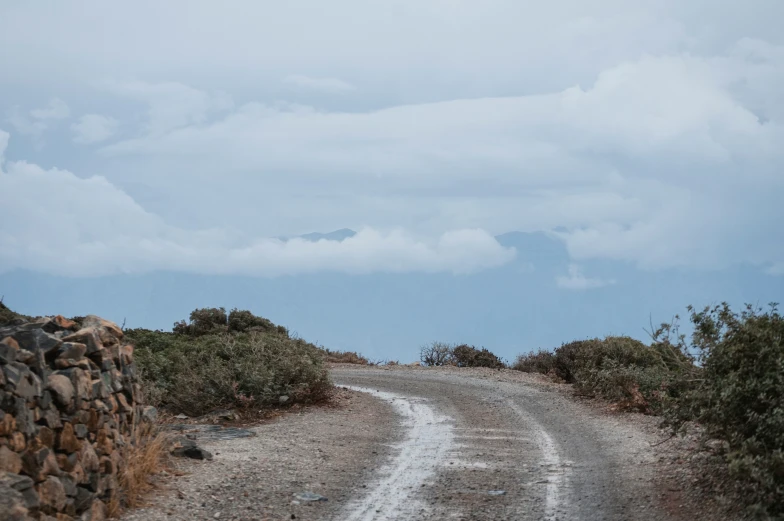 a motorcycle is driving along an empty road