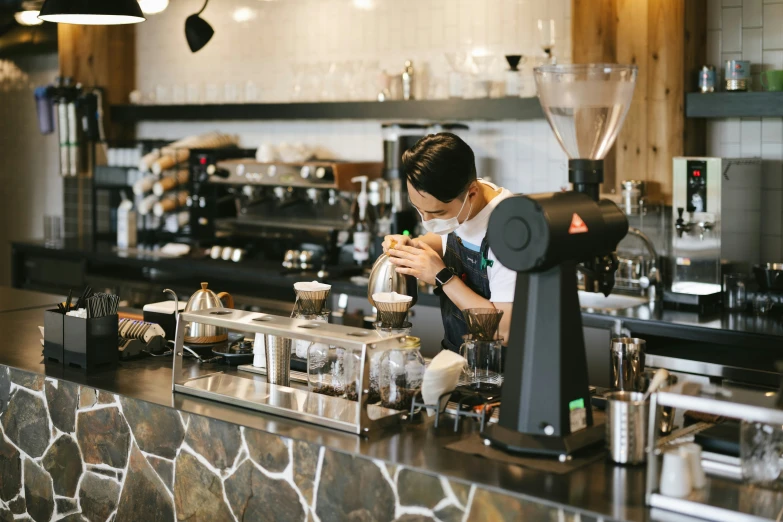a bari worker prepares drinks at a coffee shop
