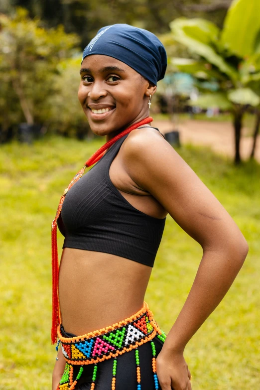 a woman smiling while wearing a belt